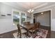 Bright dining room features a stylish chandelier, large windows, and a decorative rug at 536 Adkins Ridge Rd, Rolesville, NC 27571