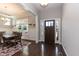 Welcoming entryway with hardwood floors, a dining table, and a wooden front door at 536 Adkins Ridge Rd, Rolesville, NC 27571