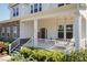 Inviting front porch featuring a swing, rocking chairs, and a 'Welcome' sign, creating a cozy entryway at 536 Adkins Ridge Rd, Rolesville, NC 27571