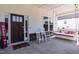 Charming front porch featuring a swing and rocking chairs for relaxing, with beautiful dark brown front door at 536 Adkins Ridge Rd, Rolesville, NC 27571