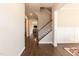 Hallway with beautiful dark hardwood floors and white trim and access to the staircase at 536 Adkins Ridge Rd, Rolesville, NC 27571