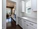 Charming kitchen area featuring white cabinets, subway tile backsplash, and light countertops at 536 Adkins Ridge Rd, Rolesville, NC 27571