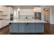 Spacious kitchen island with stainless steel appliances, quartz countertops, and stylish cabinets at 536 Adkins Ridge Rd, Rolesville, NC 27571
