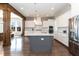 Modern kitchen features a large island, stainless steel appliances, granite countertops, and hardwood floors at 536 Adkins Ridge Rd, Rolesville, NC 27571