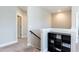 Upstairs landing with neutral decor, modern black shelving, and carpet flooring for a cozy space at 536 Adkins Ridge Rd, Rolesville, NC 27571