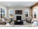 Bright living room with cozy seating, a fireplace, and views of the backyard at 536 Adkins Ridge Rd, Rolesville, NC 27571