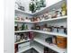 Organized pantry with shelving stocked with pantry items for functional storage in a convenient design at 536 Adkins Ridge Rd, Rolesville, NC 27571