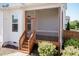 Beautiful screened in porch with wood trim and staircase down to the patio at 536 Adkins Ridge Rd, Rolesville, NC 27571