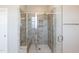 Modern glass enclosed shower featuring custom tile work, a built-in bench and shower niche at 536 Adkins Ridge Rd, Rolesville, NC 27571