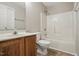 Neutral bathroom featuring a single vanity, toilet, and a shower-tub combination with white enclosure at 5414 Stanley Rd, Durham, NC 27704