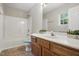 Bathroom featuring a white vanity, shower and tub combo, and bright natural light at 5414 Stanley Rd, Durham, NC 27704