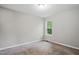 Neutral bedroom featuring carpeted floors, overhead lighting and a window providing natural light at 5414 Stanley Rd, Durham, NC 27704
