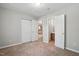 This bedroom features a connecting bathroom, multiple closets, and a view into the kitchen at 5414 Stanley Rd, Durham, NC 27704