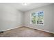 This bedroom features a large window and neutral decor at 5414 Stanley Rd, Durham, NC 27704