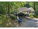 Carport area featuring boat parked on gravel lot at 5414 Stanley Rd, Durham, NC 27704
