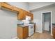 This kitchen features wood cabinets and a white range oven at 5414 Stanley Rd, Durham, NC 27704