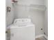 This laundry room features a white washing machine and wire shelving at 5414 Stanley Rd, Durham, NC 27704