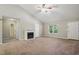 Bright living room with fireplace, vaulted ceiling, and carpet flooring at 5414 Stanley Rd, Durham, NC 27704