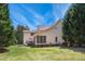 Extensive backyard with mature trees and a screened-in porch at 55 Fleming Forest Dr, Youngsville, NC 27596