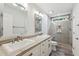 Modern bathroom with double sinks, granite countertops, and a spacious tiled shower with a glass door at 55 Fleming Forest Dr, Youngsville, NC 27596