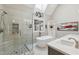 Bright bathroom with a skylight, stand-up shower, and a soaking tub at 55 Fleming Forest Dr, Youngsville, NC 27596