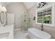 Well-lit bathroom featuring a soaking tub, stand-up shower, and double sinks at 55 Fleming Forest Dr, Youngsville, NC 27596