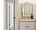 Neutral bathroom features a granite vanity and framed mirror and is located conveniently near the doorway at 55 Fleming Forest Dr, Youngsville, NC 27596