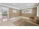 Bright bedroom featuring a neutral color palette, large window with views of outside, and a leather couch at 55 Fleming Forest Dr, Youngsville, NC 27596