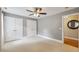 Bedroom with neutral walls, beige carpeting, a ceiling fan, and double closets at 55 Fleming Forest Dr, Youngsville, NC 27596