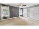 Spacious bedroom with neutral carpet, a ceiling fan, two windows, and large closets at 55 Fleming Forest Dr, Youngsville, NC 27596