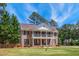 Charming brick home featuring a double balcony and beautiful landscaping at 55 Fleming Forest Dr, Youngsville, NC 27596
