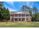 Stately brick home with a double porch and mature trees, offering classic curb appeal and southern charm at 55 Fleming Forest Dr, Youngsville, NC 27596
