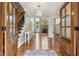 Inviting foyer with hardwood floors, staircase, chandelier, and a glimpse into the living area with fireplace at 55 Fleming Forest Dr, Youngsville, NC 27596