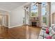 Bright living room featuring a fireplace, hardwood floors, and access to the outdoors at 55 Fleming Forest Dr, Youngsville, NC 27596