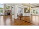 Open-concept living room with fireplace, hardwood floors, and views into the dining area at 55 Fleming Forest Dr, Youngsville, NC 27596