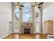 Bright living room with a stone fireplace, large windows, high ceilings, and access to the outdoors at 55 Fleming Forest Dr, Youngsville, NC 27596