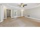 Spacious primary bedroom with a ceiling fan, carpeted floors, and a walk-in closet at 55 Fleming Forest Dr, Youngsville, NC 27596