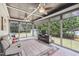 Bright sun room with ceiling fans, tile floors, a TV, and great views of the well-manicured backyard at 55 Fleming Forest Dr, Youngsville, NC 27596