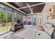 Cozy sun room features ceiling fans, tile floors, a TV, a neutral-colored couch, and great views of the backyard at 55 Fleming Forest Dr, Youngsville, NC 27596