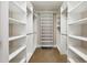Bright walk-in closet with rows of shelving and hanging rods at 55 Fleming Forest Dr, Youngsville, NC 27596