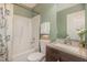 The bathroom features a shower and tub, vanity sink, and toilet with decorative accents at 5600 Sherrif W Pl, Raleigh, NC 27610