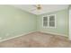 The bedroom features neutral carpeting and bright natural light from the window at 5600 Sherrif W Pl, Raleigh, NC 27610