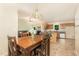 Bright dining area featuring wood table set, pendant lighting and an open concept with adjacent living room and kitchen at 5600 Sherrif W Pl, Raleigh, NC 27610