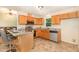 Well-lit kitchen featuring granite countertops, stainless steel appliances, and access to living room at 5600 Sherrif W Pl, Raleigh, NC 27610