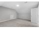 Attic featuring neutral carpet, crisp white trim and door, and a skylight at 5612 Sandy Trail Dr, Knightdale, NC 27545