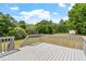 Spacious wooden deck overlooking a lush green yard with mature trees and storage shed at 5612 Sandy Trail Dr, Knightdale, NC 27545