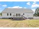 Home's back exterior featuring a small deck, white siding, and a fenced-in yard at 5612 Sandy Trail Dr, Knightdale, NC 27545