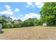 Large, grassy backyard with trees and storage shed at 5612 Sandy Trail Dr, Knightdale, NC 27545
