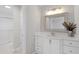 Bright bathroom featuring white vanity with marble countertop, decorative mirror, and tiled floors at 5612 Sandy Trail Dr, Knightdale, NC 27545