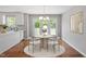 Bright dining area featuring large windows and a modern chandelier at 5612 Sandy Trail Dr, Knightdale, NC 27545